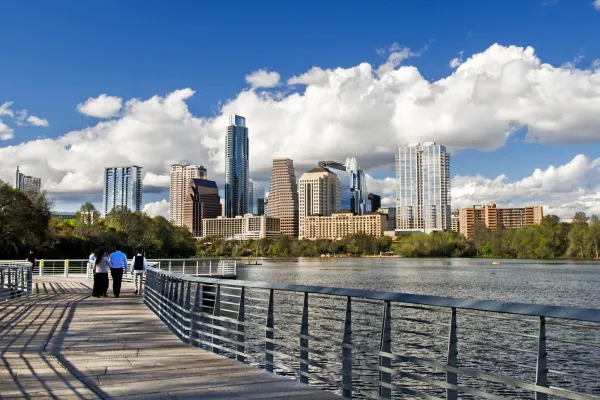 Austin's skyline seen from the Lady Bird Boardwalk on a beautiful day with clouds