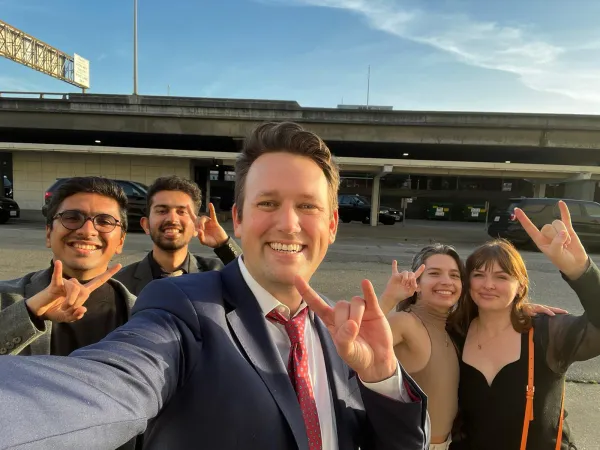 Student team giving the "Hook 'em Horns" hand signal