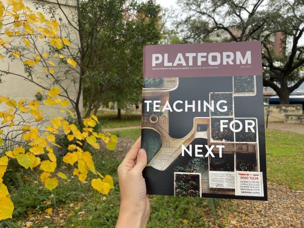 Platform Teaching for Next held up in front of fall foliage outside the School of Architecture