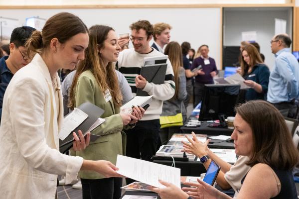 A row of students seen interacting with employers at 2023 Career Fair