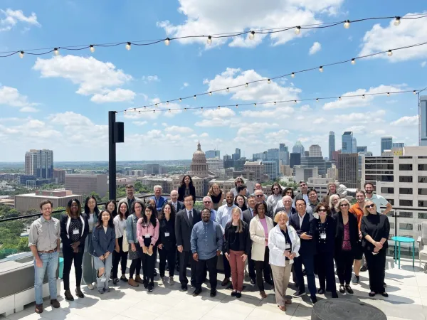 CM2 Summer Forum participants posing for a group photo with the Texas State Capitol in the background