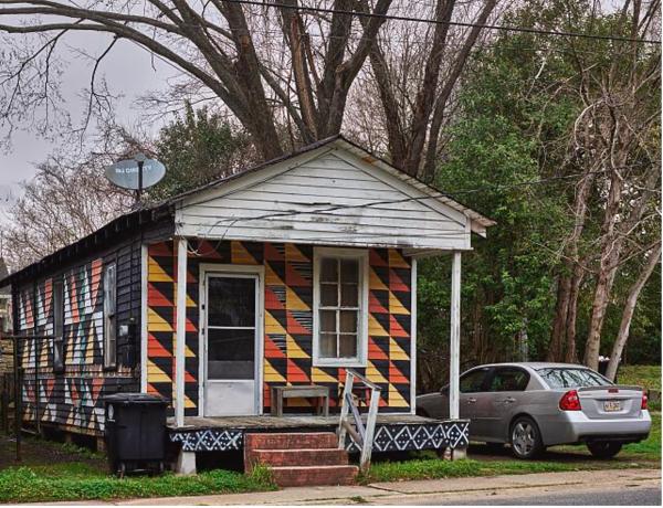 Exterior of a house in Louisiana with colorful triangles painted on the facade