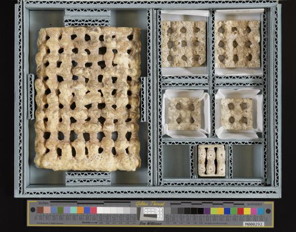 Six rectangular samples of Wolf Hilbertz's biorock technology in a box. The largest is on the left, with five smaller pieces on the right.