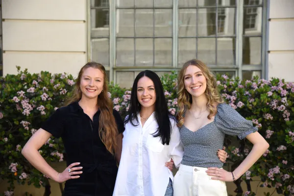 Three interior design students in the Goldsmith Courtyard