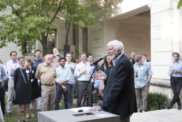Sinclair Black speaking in front of a crowd in the Goldsmith Courtyard