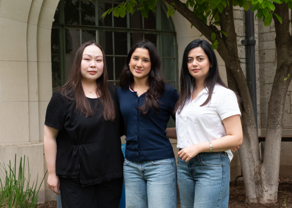 Three women who won the metropolis 100 award stand in the goldsmith courtyard together