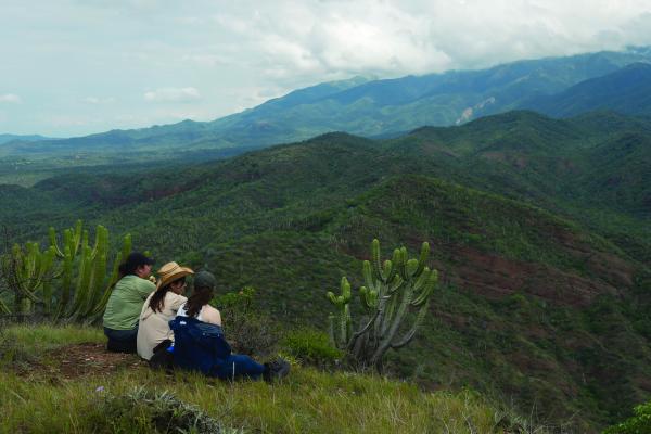 Students look out over a verdant mountain landscape in the Tehuacán-Cuicatlán Biosphere Reserve 
