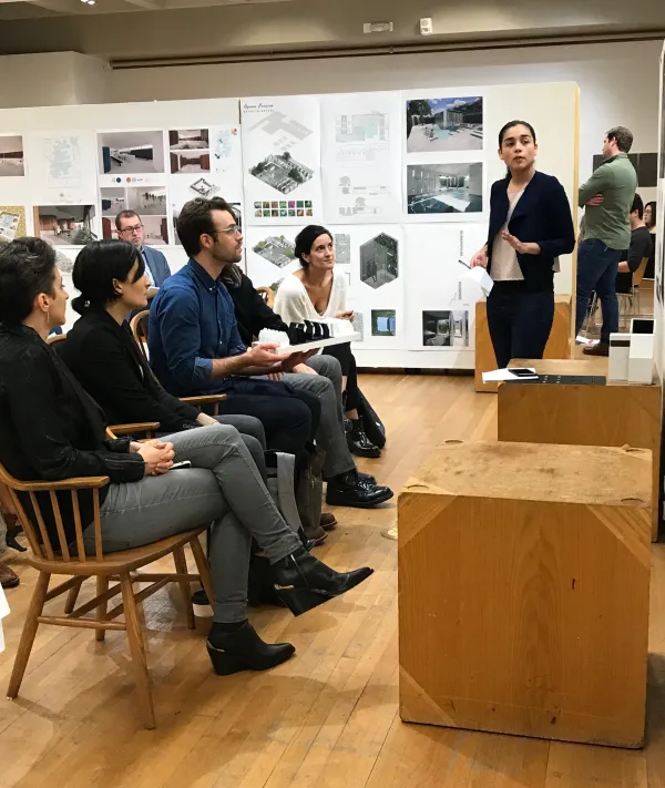 Nerea Feliz engaging with a student during their final review presentation in Fall 2019