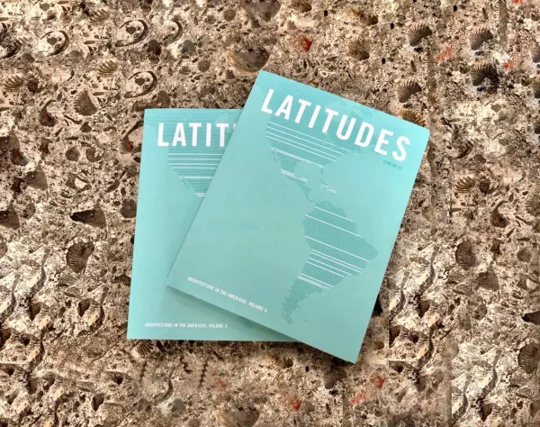 Two copies of CENTER 22, chronicling the final years of the Latitudes Conference, placed atop a stone bench