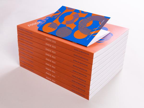 Stack of copies of ISSUE XVI against a white backdrop with the orange spines prominent