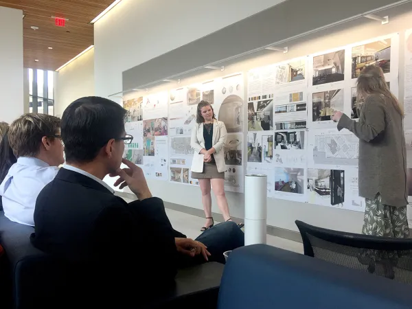 Students present to a panel of reviewers at Dell Medical