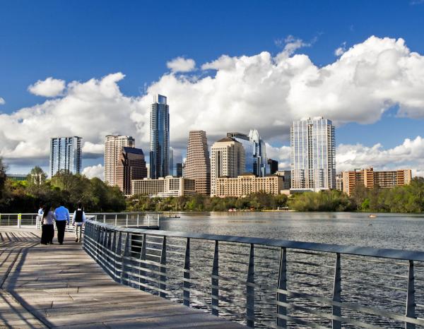 Austin's skyline seen from the Lady Bird Boardwalk on a beautiful day with clouds