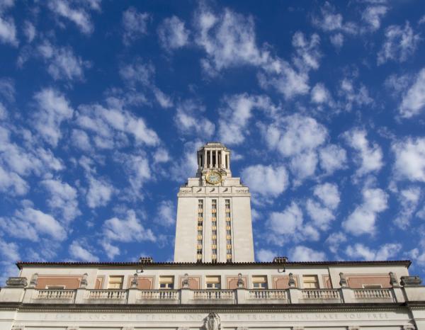 View of the UT Tower in front of bright blue skies and buttery clouds