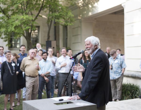 Sinclair Black speaking in front of a crowd in the Goldsmith Courtyard