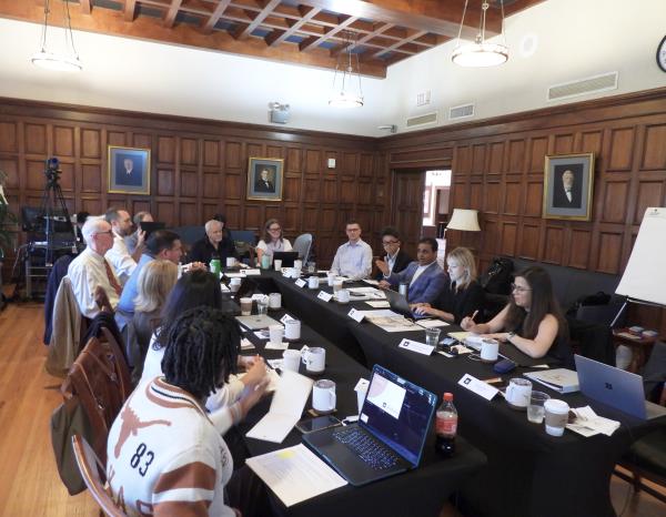 People seated at a round table in a discussion
