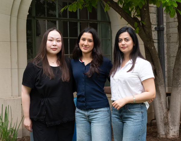 Three women who won the metropolis 100 award stand in the goldsmith courtyard together