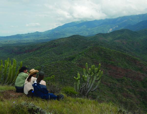 Students look out over a verdant mountain landscape in the Tehuacán-Cuicatlán Biosphere Reserve 