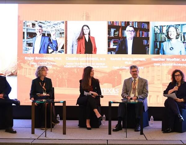 ut faculty sitting on a panel at a summit conference in seoul
