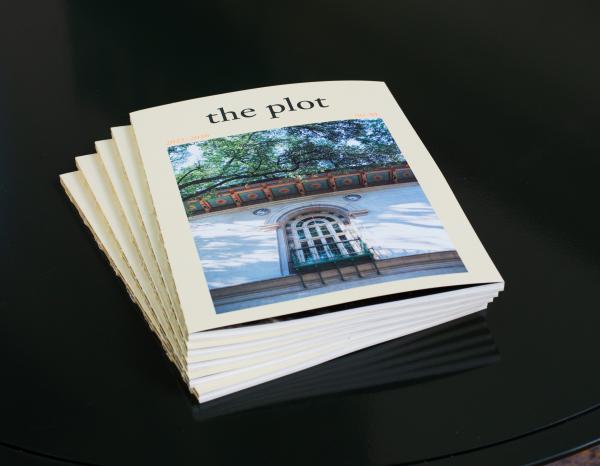 Stack of publications entitled The Plot on a table