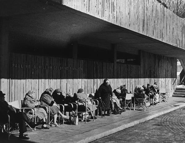 Black and white historic image of elderly residents sitting in front of a nursing home. Representing research from Willa Granger's dissertation.