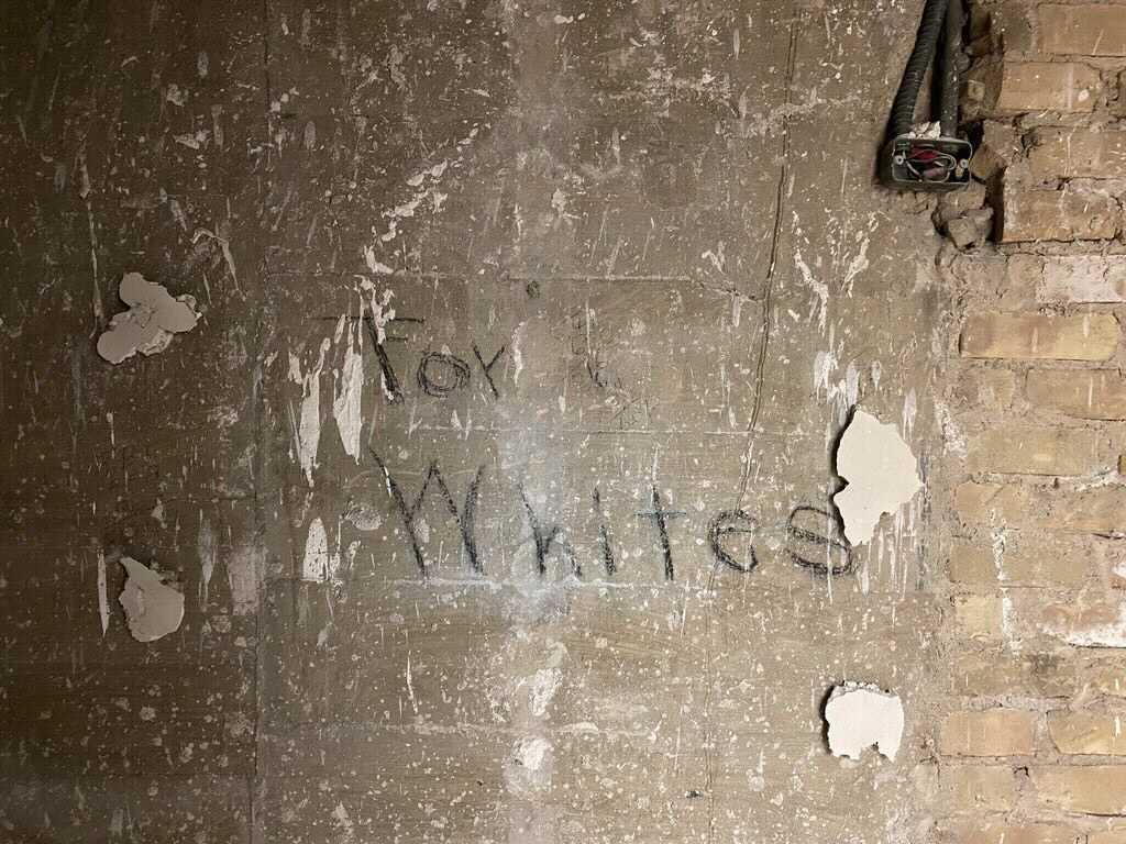 The words "For Whites" written on a wall in Battle Hall, circa 1910s