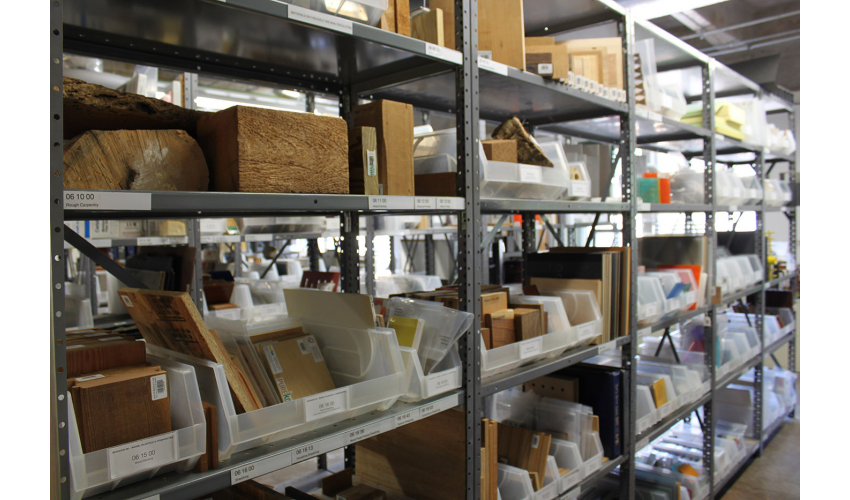 Material samples on display on a metal shelving system