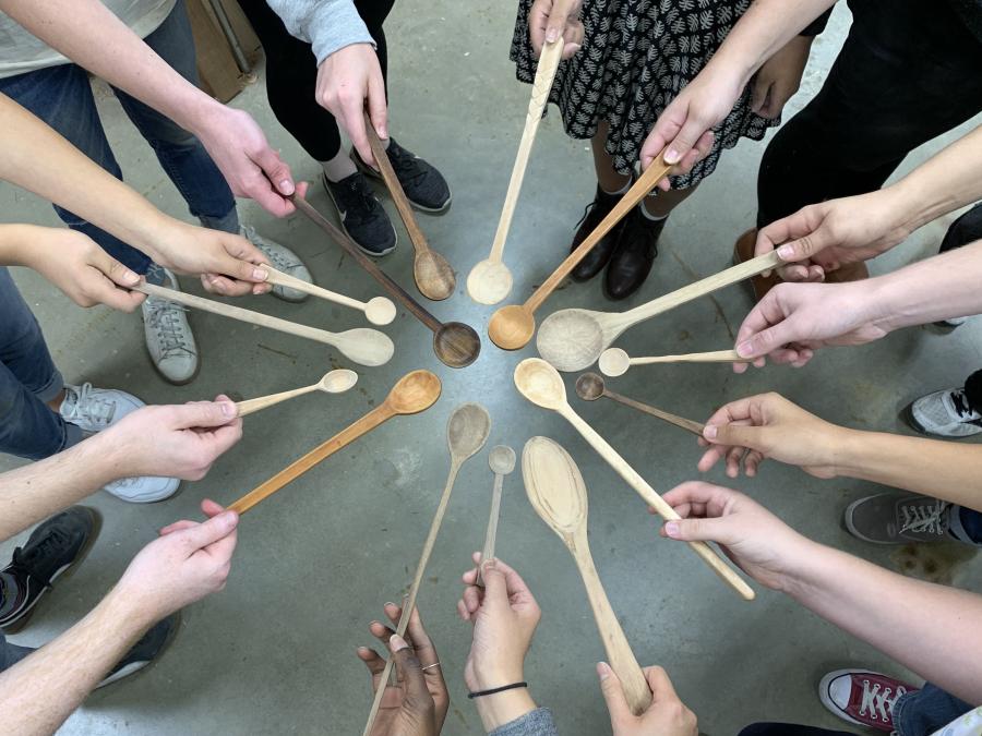 The students show off their handcrafted wooden spoon designs