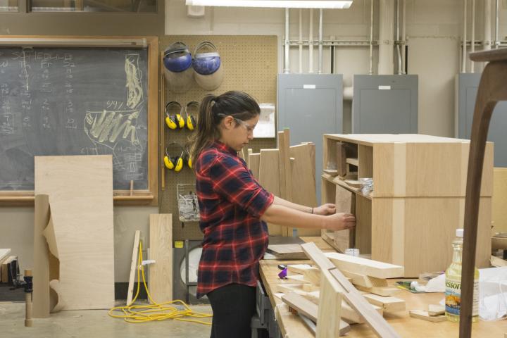A student working on a piece of furniture in the Build Lab