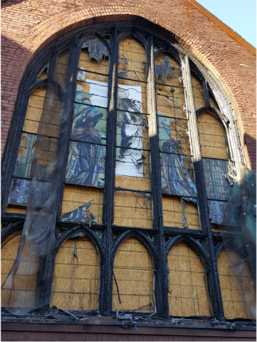 Historic stained glass window affected by fire damage