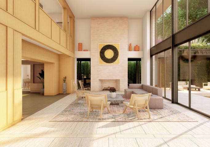 Bright, natural light filled living room with almost yellow wood paneling on the walls of the left, and floor to ceiling windows looking out to an interior patio on the left. In the living room space there is a low profiled couch, a few chairs, and a fireplace located in the middle of the frame