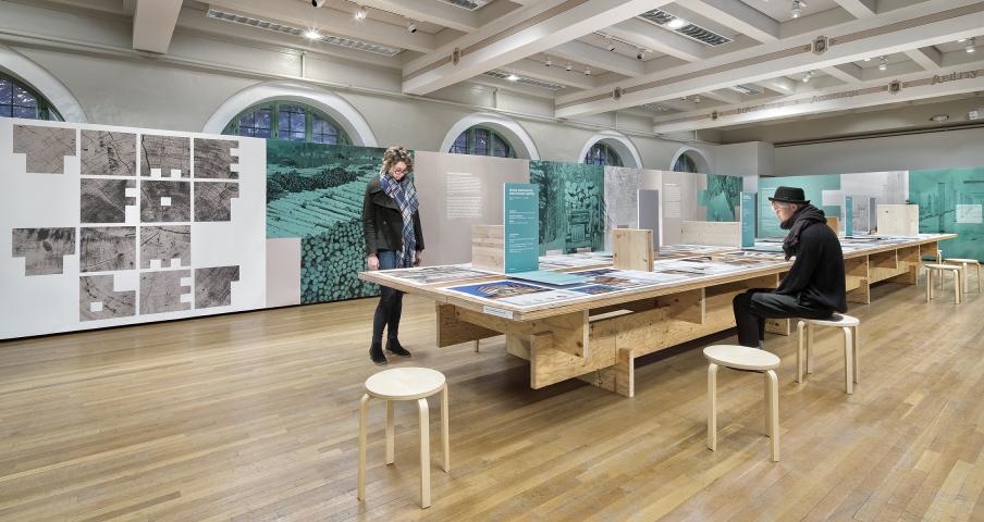 Two people standing in Uli's Time for Timber exhibit