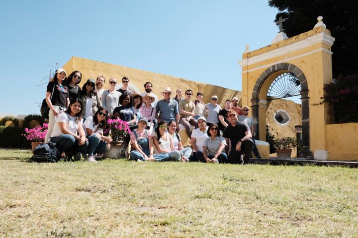 A group of students in front of a yellow building in Mexico