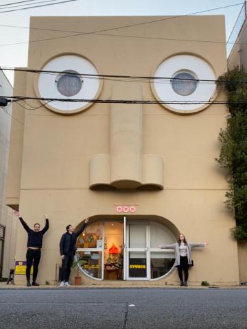Students pose in front of a building in Tokyo