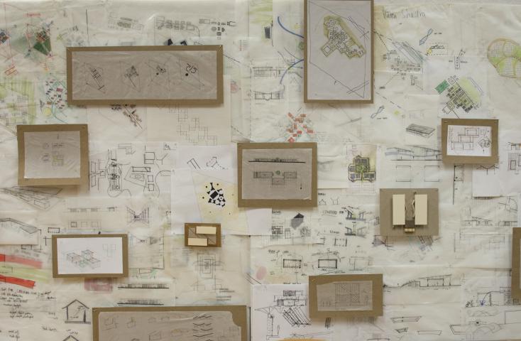 Various sketches and drawings pinned up on a wall