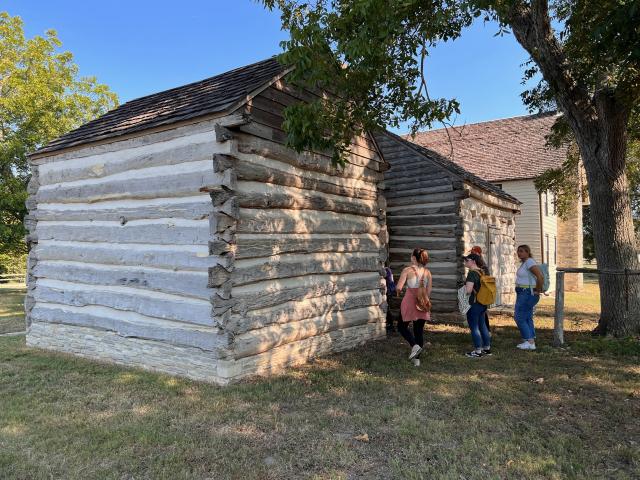 Log cabin and students