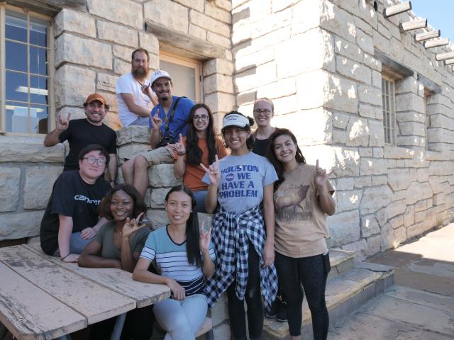 Group shot in front of a stone structure