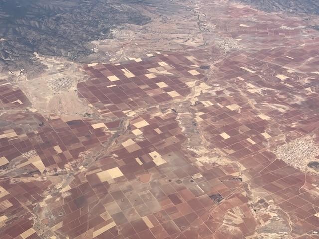 Aerial view of property plots in various shades of red and brown