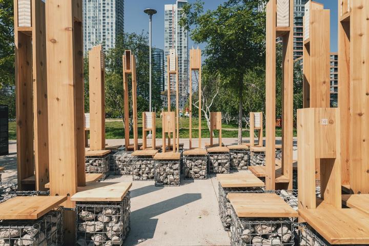 An close up of several pieces of wood furniture/structures in the middle of downtown Toronto.