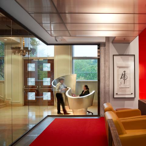 Entryway of a hospitality building with a sculptural front desk