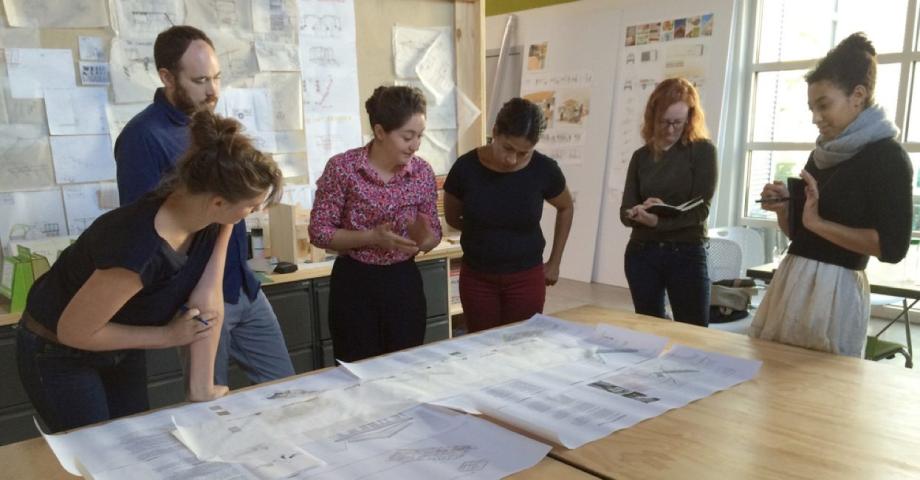 Students and professors reviewing project documents.